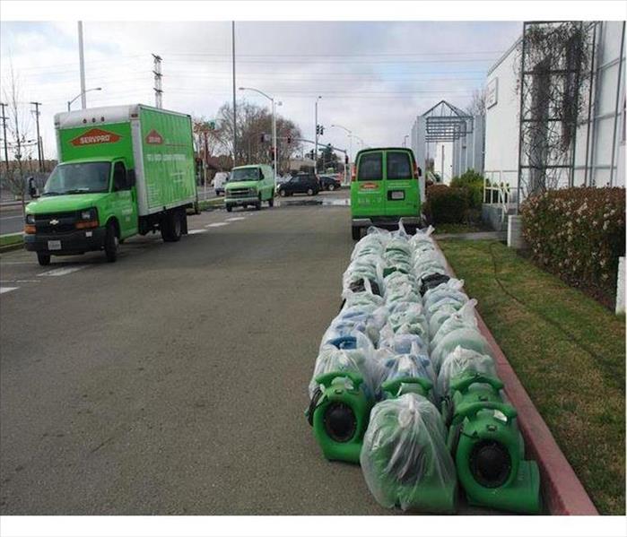 SERVPRO Vehicles and Rows of AIr Movers Outside