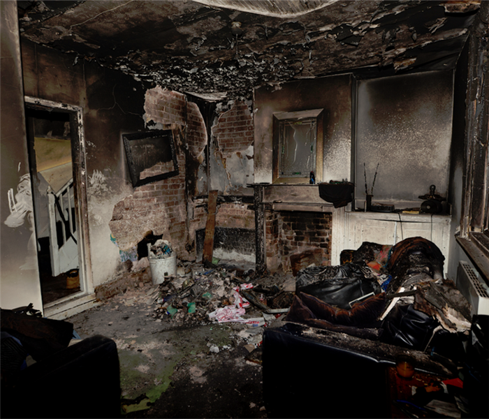 a fire damaged living room with debris everywhere