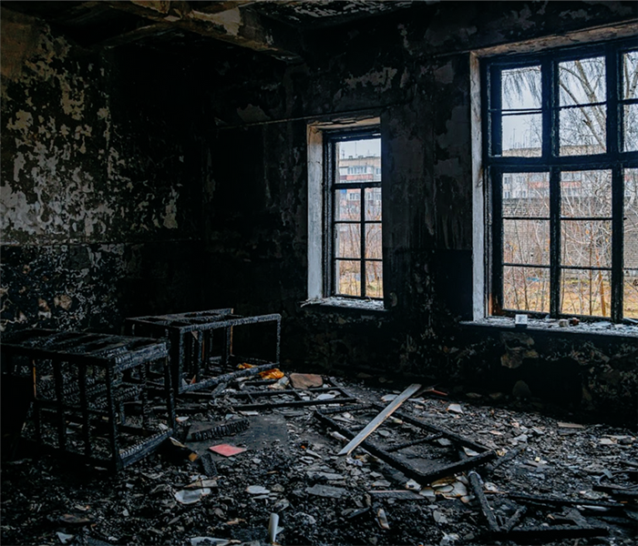 a room covered with soot and remains of burned items